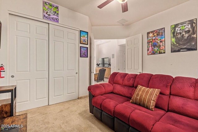 carpeted living room with a ceiling fan
