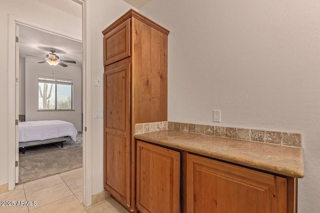 ensuite bathroom featuring tile patterned flooring, ensuite bath, and ceiling fan