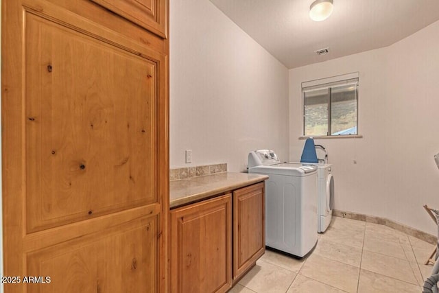 washroom with washer and clothes dryer, cabinet space, visible vents, light tile patterned floors, and baseboards