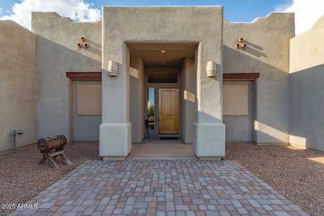 doorway to property with stucco siding