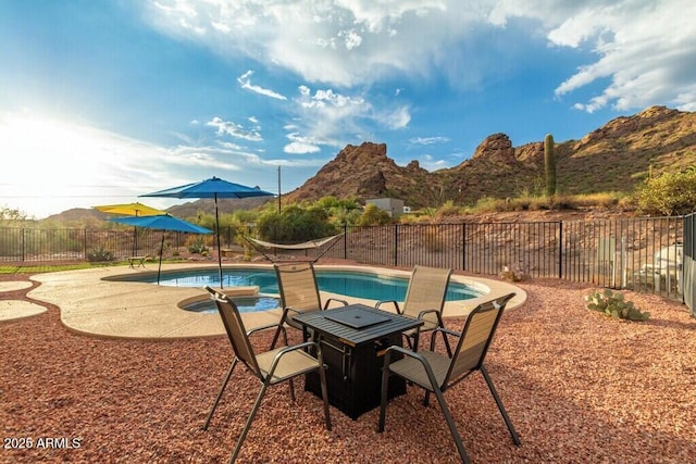 view of pool with a patio, a fenced in pool, a mountain view, and a fenced backyard