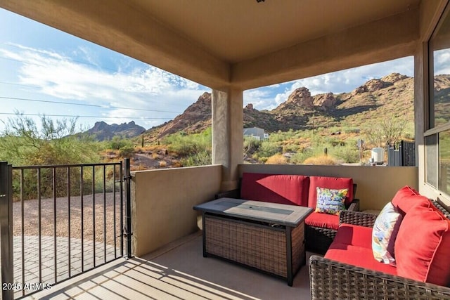 balcony featuring a mountain view and an outdoor living space