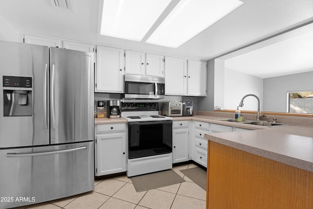 1604 W Kerry Ln, Phoenix, AZ 85027 - kitchen featuring visible vents, a sink, stainless steel appliances, white cabinets, and light tile patterned flooring