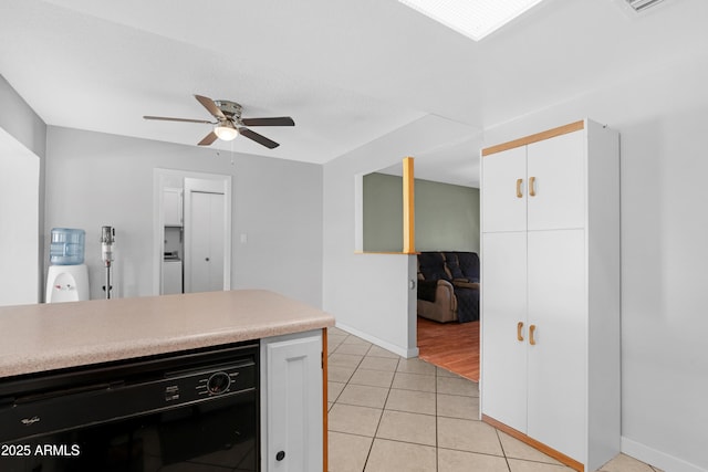 1604 W Kerry Ln, Phoenix, AZ 85027 - kitchen with light countertops, black dishwasher, light tile patterned flooring, white cabinetry, and a ceiling fan