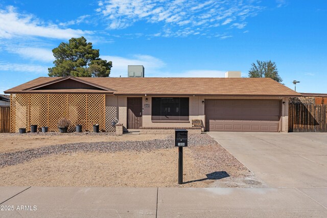 1604 W Kerry Ln, Phoenix, AZ 85027 - ranch-style house featuring an attached garage, brick siding, driveway, and roof with shingles