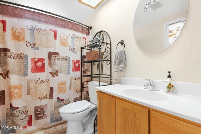 1604 W Kerry Ln, Phoenix, AZ 85027 - full bathroom with vanity, a shower with shower curtain, visible vents, stone finish floor, and toilet
