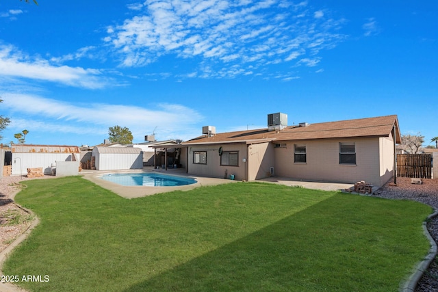 1604 W Kerry Ln, Phoenix, AZ 85027 - rear view of property with a lawn, a storage shed, an outdoor structure, a fenced backyard, and a patio area