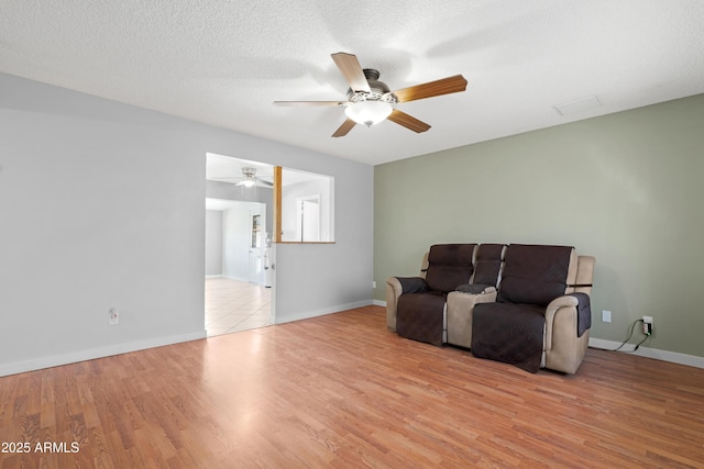 1604 W Kerry Ln, Phoenix, AZ 85027 - living area with visible vents, a ceiling fan, a textured ceiling, wood finished floors, and baseboards