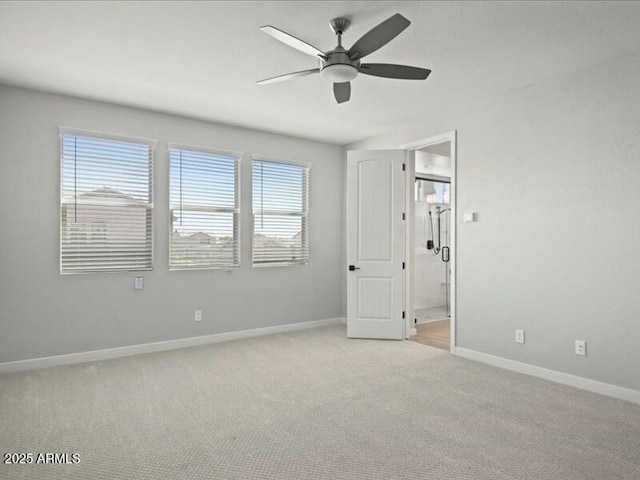 unfurnished room with light carpet, ceiling fan, and baseboards