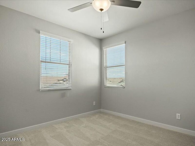 empty room featuring carpet flooring, ceiling fan, and baseboards