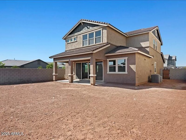 rear view of house featuring a patio, central AC unit, a fenced backyard, and stucco siding