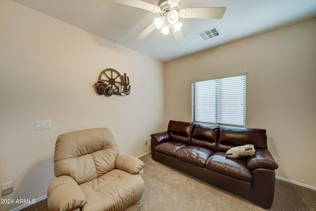 living room featuring ceiling fan and light colored carpet