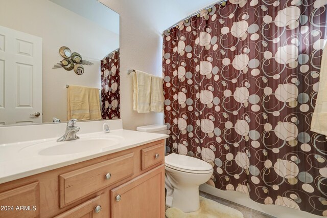 bathroom featuring tile patterned floors, vanity, and toilet