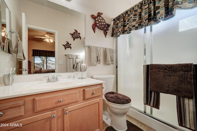 bathroom with vanity, tile patterned flooring, ceiling fan, toilet, and an enclosed shower