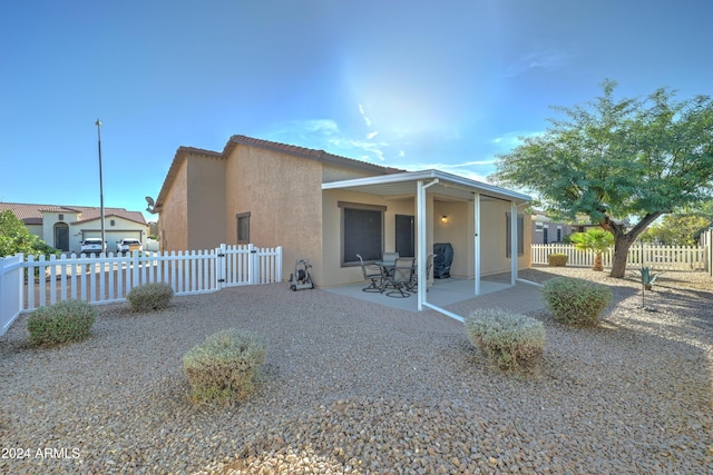 back of property featuring a patio area