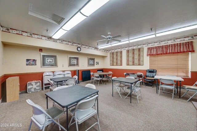 dining area featuring carpet and ceiling fan