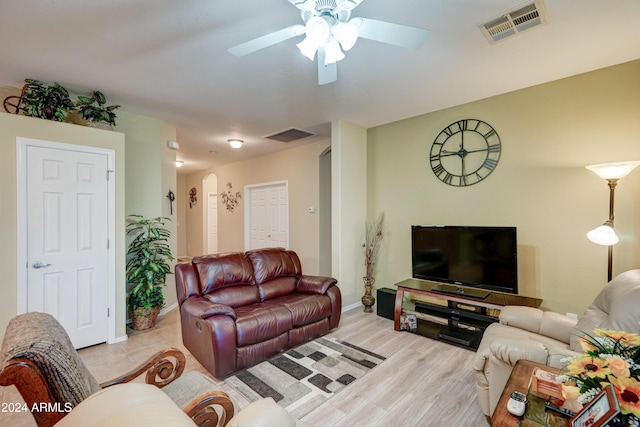 living room with ceiling fan and light wood-type flooring