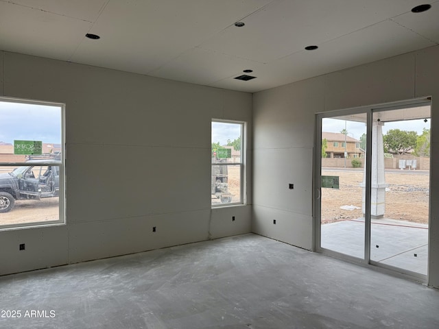 6452 E Omega Cir, Mesa, AZ 85215 - empty room with healthy amount of natural light and unfinished concrete floors