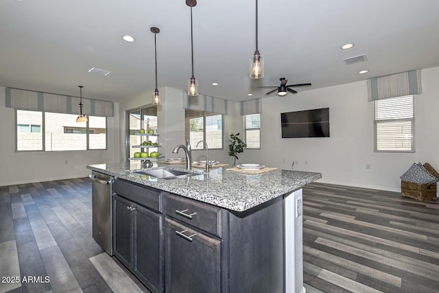 kitchen with open floor plan, visible vents, a sink, and stainless steel dishwasher