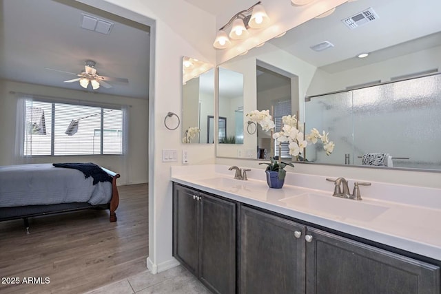 full bath with visible vents, a sink, and ensuite bathroom