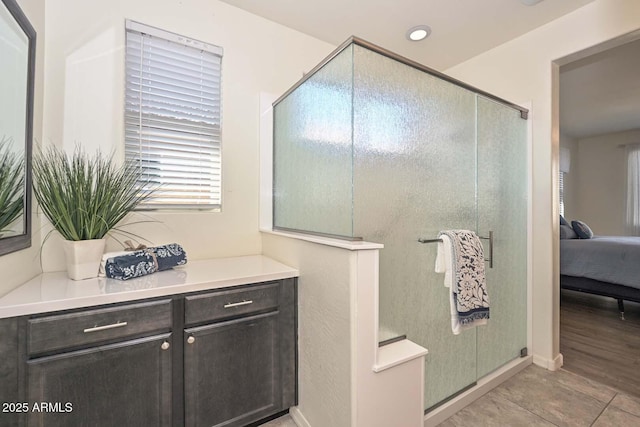 full bathroom featuring a shower with door, recessed lighting, vanity, and ensuite bathroom