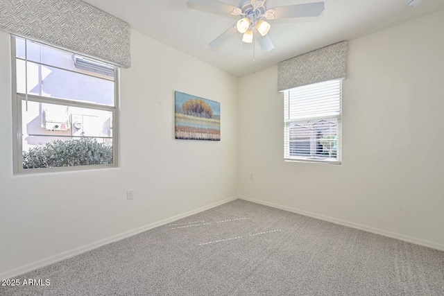 spare room with carpet floors, baseboards, and a ceiling fan