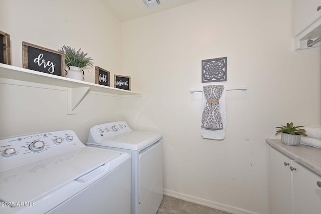 laundry area featuring visible vents, baseboards, cabinet space, and washer and dryer