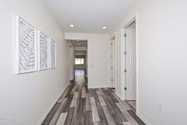 corridor with recessed lighting, dark wood-style flooring, and baseboards