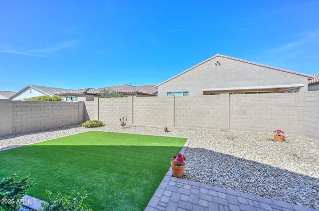 view of yard with a fenced backyard