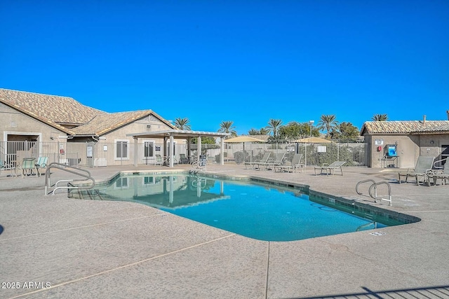 pool featuring a patio area and fence