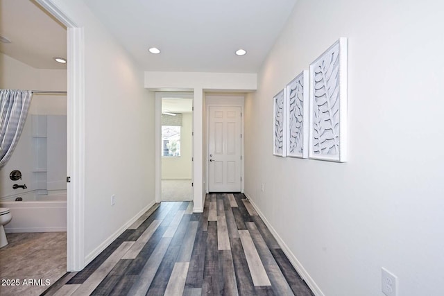 hall with baseboards, dark wood-style flooring, and recessed lighting