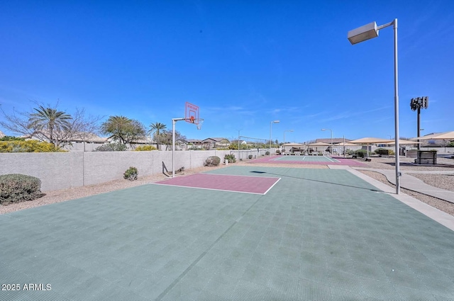 view of basketball court with community basketball court and fence