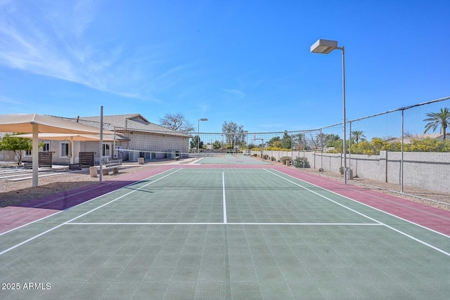 view of sport court featuring fence