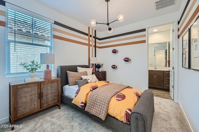 3339 S Lily Ave, Mesa, AZ 85212 - bedroom with light carpet, ensuite bathroom, a chandelier, a sink, and baseboards