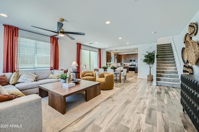 3339 S Lily Ave, Mesa, AZ 85212 - living room featuring light wood-style flooring, stairway, a ceiling fan, and recessed lighting