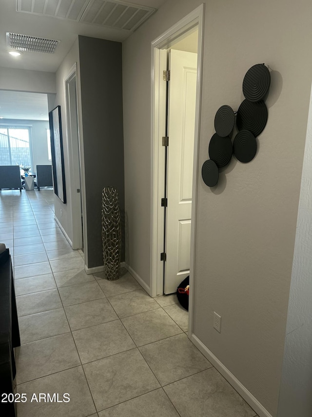 hallway featuring light tile patterned floors