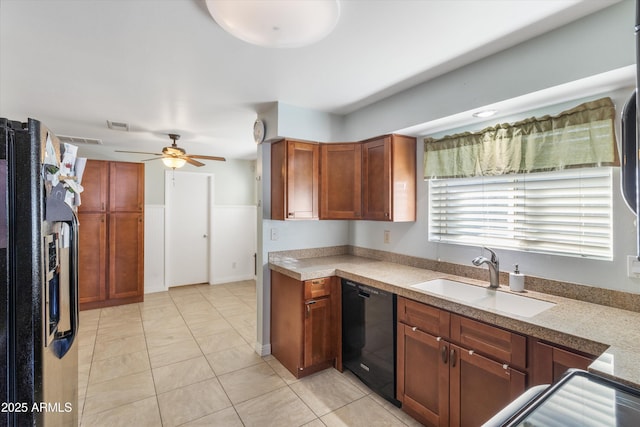 kitchen with black appliances, a ceiling fan, a sink, brown cabinetry, and light tile patterned floors