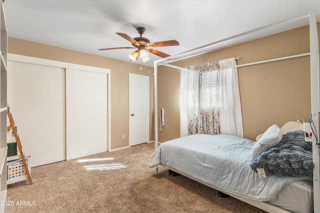 bedroom with a closet, carpet flooring, and a ceiling fan