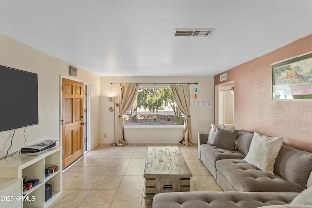 living room with light tile patterned flooring and visible vents