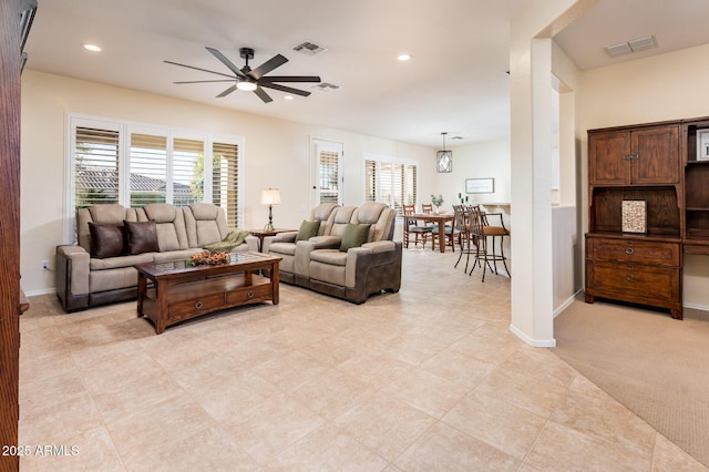 living room featuring light carpet and ceiling fan