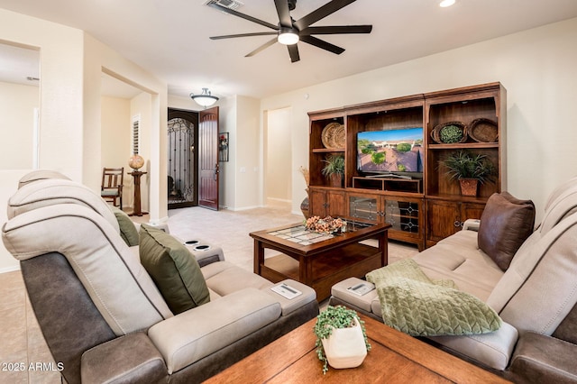 living room with ceiling fan and tile patterned floors