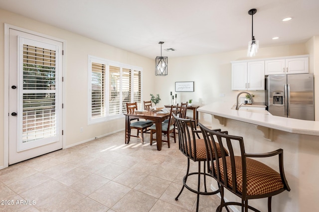 dining area with light tile patterned floors and sink