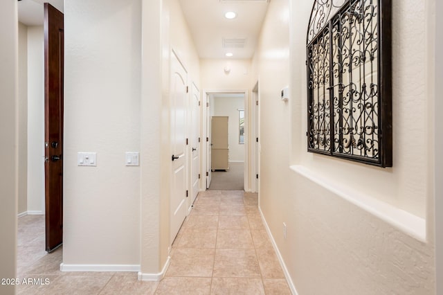 corridor with light tile patterned flooring