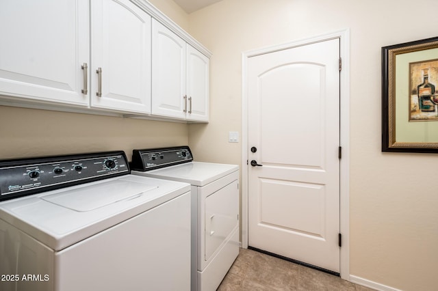 laundry area featuring cabinets and washing machine and clothes dryer