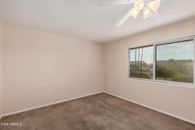 spare room with ceiling fan, carpet floors, and a textured ceiling