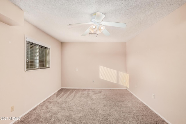 unfurnished room featuring ceiling fan, carpet floors, and a textured ceiling