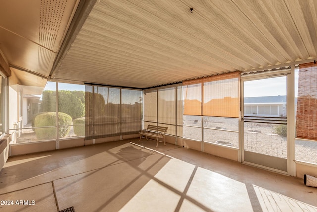 unfurnished sunroom with wooden ceiling