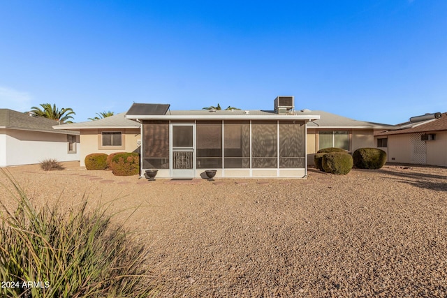 rear view of house featuring a sunroom and cooling unit