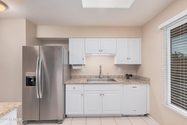 kitchen featuring white cabinetry, dishwasher, sink, stainless steel refrigerator with ice dispenser, and light tile patterned flooring