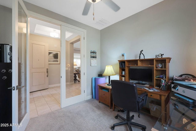 home office featuring french doors, light colored carpet, and ceiling fan